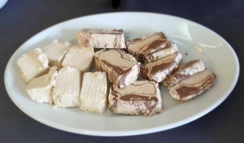 a white plate with chocolate desserts on a table at Hotel Rodon in Paralia Katerinis