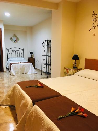 a hotel room with two beds with brown blankets at La casita Santa Bárbara in Macastre