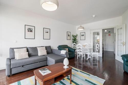 a living room with a couch and a table at Varandas do Funchal II by An Island Apart in Funchal