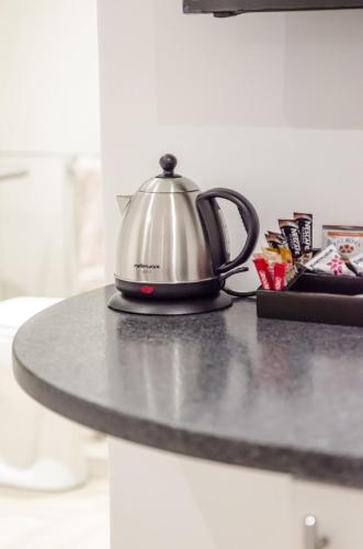 a tea kettle sitting on top of a counter at Somerset View Guest House in Somerset West