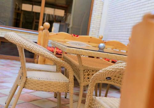 a wooden table and chairs on a patio at Premier in Samarkand