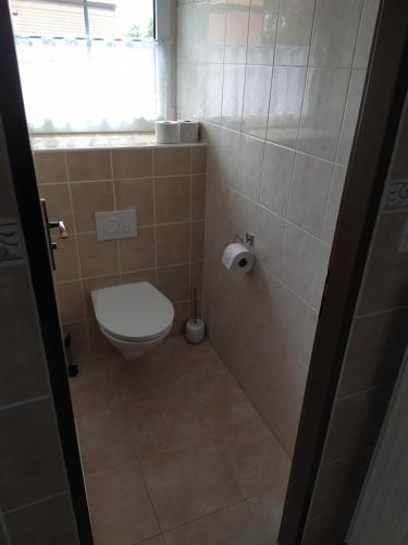 a small bathroom with a toilet and a window at Penzion a restaurace U Kalendů in Strážnice