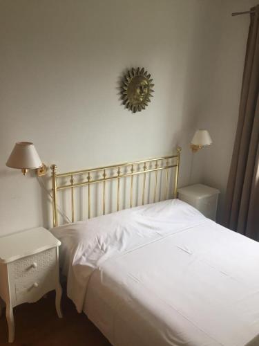 a bedroom with a white bed and a table and a mirror at Apartment Luiza Funtana in Funtana
