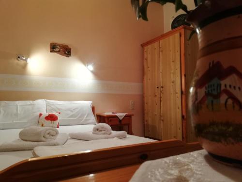a bedroom with a bed with towels on it at Villa Horizon in Tsagarada
