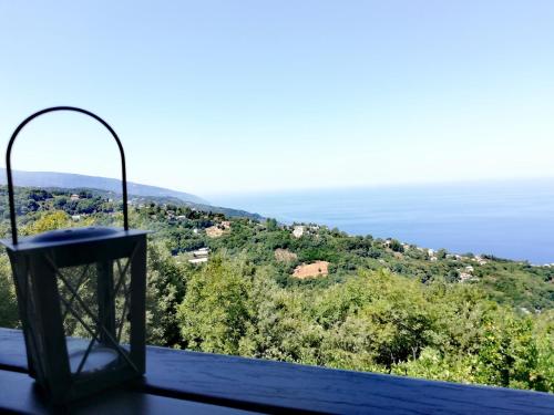 a lamp sitting on top of a table overlooking the ocean at Villa Horizon in Tsagarada