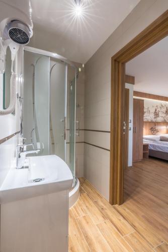 a bathroom with a sink and a shower at Górska Grań in Poronin