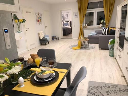 een eetkamer en een woonkamer met een tafel en stoelen bij Ferienwohnung Domizil am Delft Emden in Emden