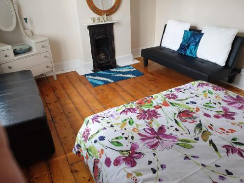 a bedroom with a bed and a fire place at sea view cottage in Bideford