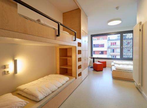 a bedroom with a bunk bed in a room at Youth Hostel Esch/Alzette in Esch-sur-Alzette