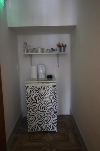 a small refrigerator in a corner of a room at ODEON Apartment And Rooms in Rijeka