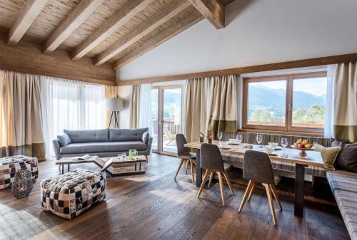 a living room with a table and a couch at Kaiserlodge in Scheffau am Wilden Kaiser
