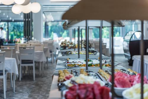 a buffet line with plates of food in a restaurant at Hotel Fontana Vrnjačka Banja in Vrnjačka Banja