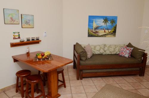 a living room with a couch and a table at Pousada Villa Maritima in Juquei