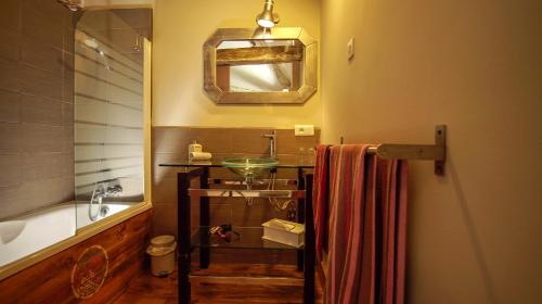 a bathroom with a sink and a bath tub at La part des anges in Pupillin