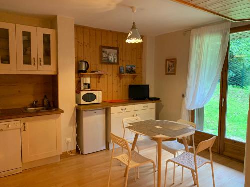 - une cuisine avec une table, des chaises et une table dans l'établissement Chamonix Studio Jardin, à Chamonix-Mont-Blanc