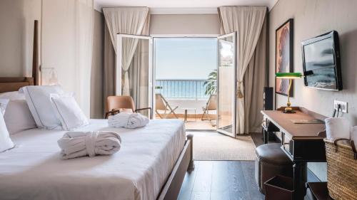 a hotel room with two beds and a view of the ocean at Be Live Adults Only La Cala Boutique Hotel in Palma de Mallorca