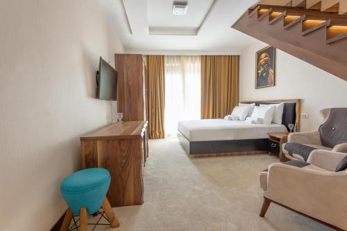 a hotel room with a bed and a couch at Waikiki Apartments in Tivat