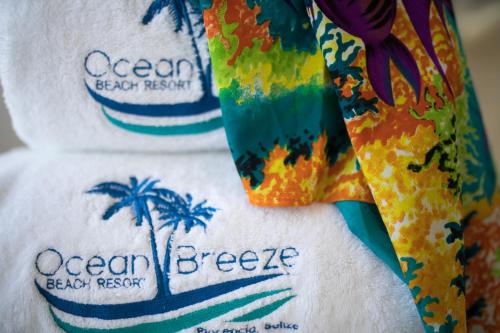 three towels with the words ocean breeze on them at Ocean Breeze in Placencia Village