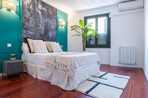 a bedroom with a bed with a green wall at Plaza España in Madrid