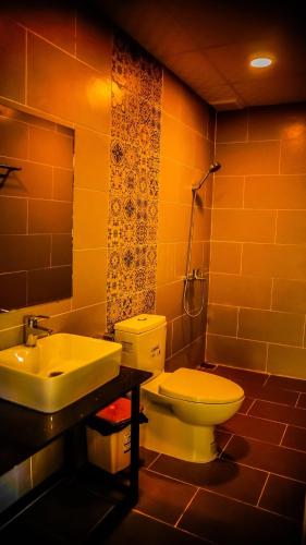 a bathroom with a sink and a toilet at Berry Valley Homestay in Da Lat