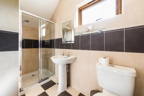 a bathroom with a toilet sink and a shower at The Atholl Palace in Pitlochry