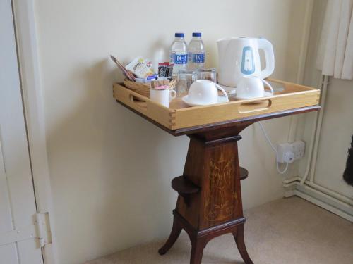 a table with a coffee maker on top of it at The Greyhound - Historic former Inn in Glemsford