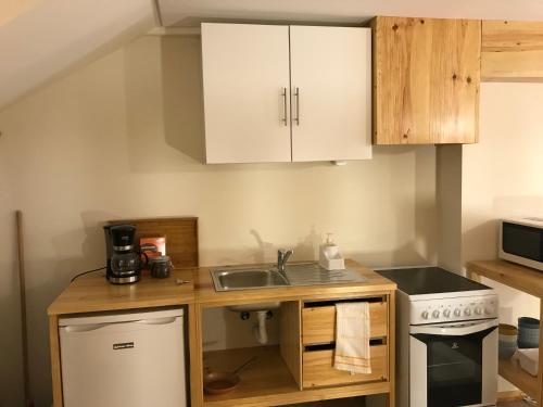 a small kitchen with a sink and a stove at Casa Portas 8&10 in Lamego