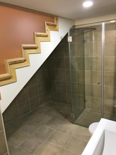 a bathroom with a shower and a staircase at Casa Portas 8&10 in Lamego