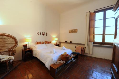 a bedroom with a large white bed and a window at Acacia Firenze - Primula in Florence