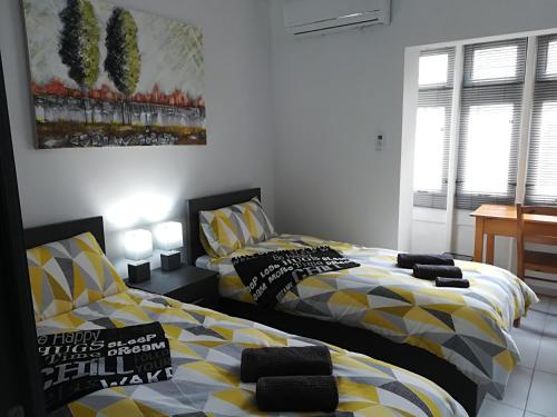 two beds sitting next to each other in a bedroom at Luxury Apartment close to seafront in Sliema
