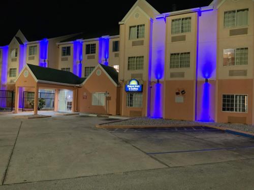 a hotel with blue lights on the front of it at Days Inn & Suites by Wyndham Tampa/Raymond James Stadium in Tampa