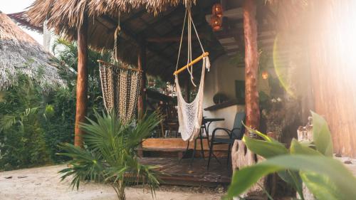 a porch of a house with a hammock at Casa Mech in Holbox Island