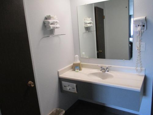 a bathroom with a sink and a mirror at Americas Best Value Inn Billings in Billings