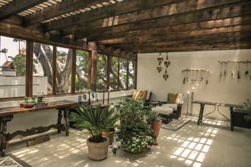 a living room with a table and some plants at Casa de Sierra Nevada, A Belmond Hotel, San Miguel de Allende in San Miguel de Allende