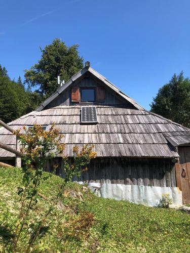 an old barn with a window on the side of it at Mountain Lodge Suška Koča in Stahovica