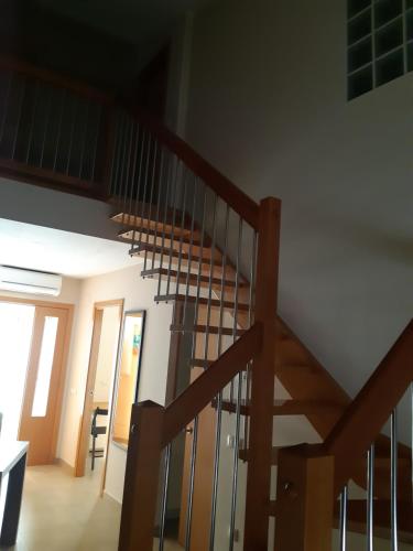 a wooden staircase in a house with a stair railing at Cal Ribero in Villanova de la Sal