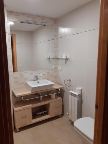 a bathroom with a sink and a mirror at Cal Ribero in Villanova de la Sal