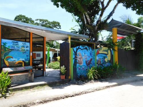 a building with a mural on the side of it at Cabinas Cahuita in Cahuita