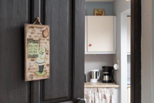 a door with a sign on it in a kitchen at Filia Rooms in Matala