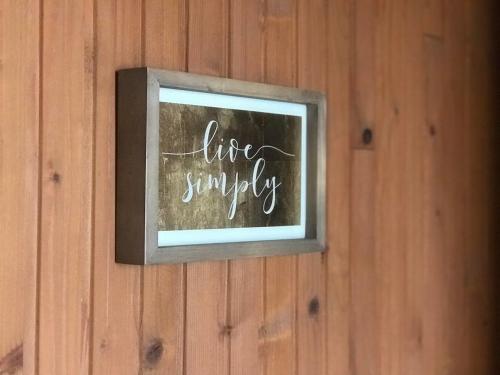 a sign that says life simplify on a wall at Villa Irena in Visoko