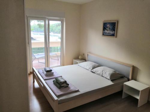 Ένα ή περισσότερα κρεβάτια σε δωμάτιο στο Apartments Brlečić