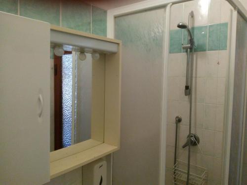 a bathroom with a mirror and a shower in it at Hotel Lea in Grosseto