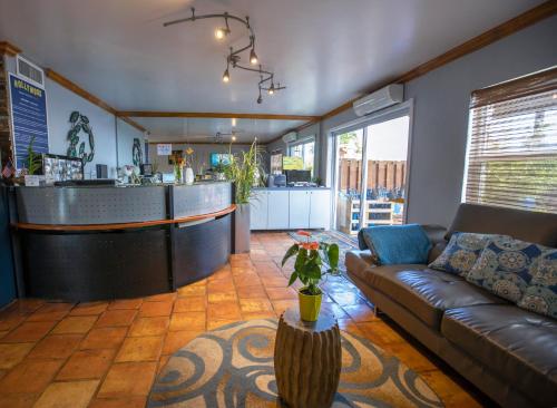 a living room with a couch and a bar at Hollywood Beach Suites and Hotel in Hollywood