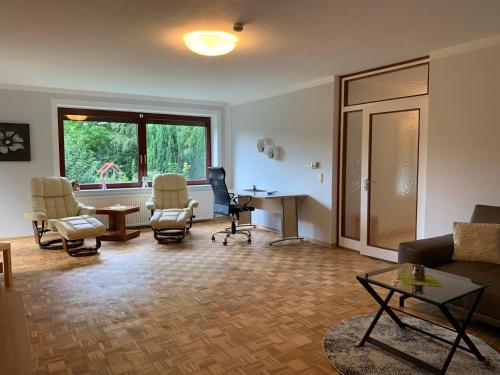 a living room with chairs and a couch and a table at Elbe Ferienwohnung Glückstadt in Glückstadt