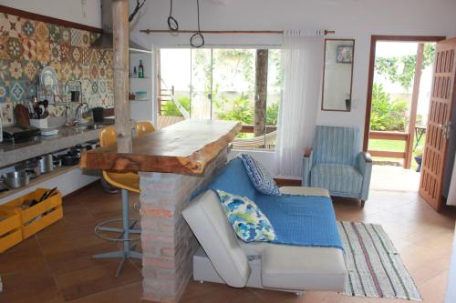 a kitchen with a counter and a table and chairs at Hostel Luz in Anchieta