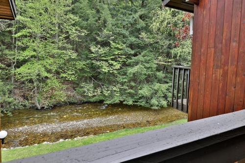a view of a river from the porch of a house at Cedarbrook Queen Studio 207 in Killington
