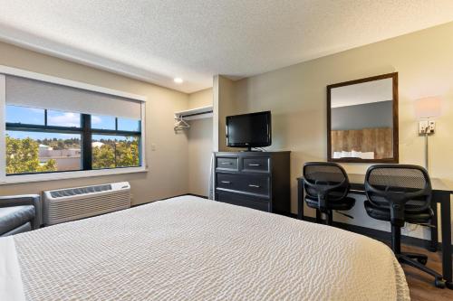 a bedroom with a bed and a desk and a television at Extended Stay America Suites - San Ramon - Bishop Ranch - East in San Ramon