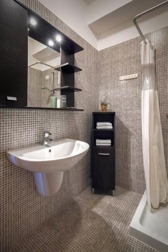 a bathroom with a sink and a mirror at LA CHIARETTO SUITE in Bardolino