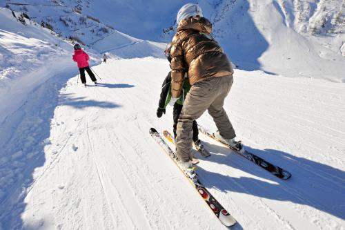 a person is on skis in the snow at Hotel TURNA Malbun in Malbun