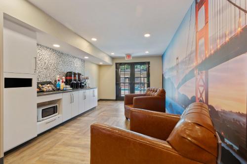 a living room with two couches and a kitchen at Extended Stay America Suites - San Ramon - Bishop Ranch - East in San Ramon